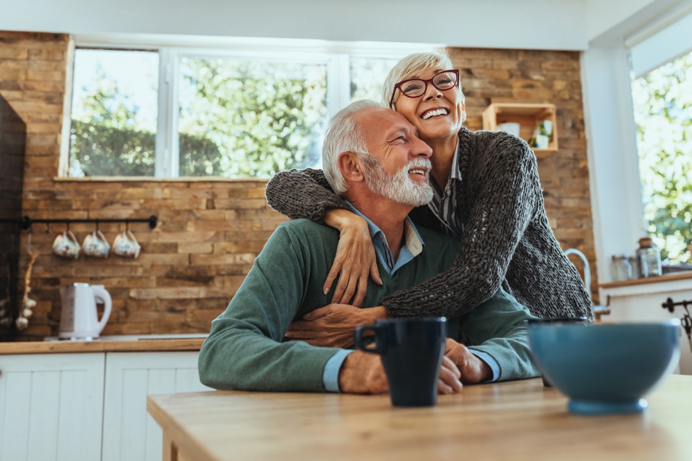 A man and a woman hugging in a kitchen